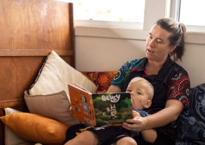 childcare traineeship opportunity - female early childhood educator reading a book with a child